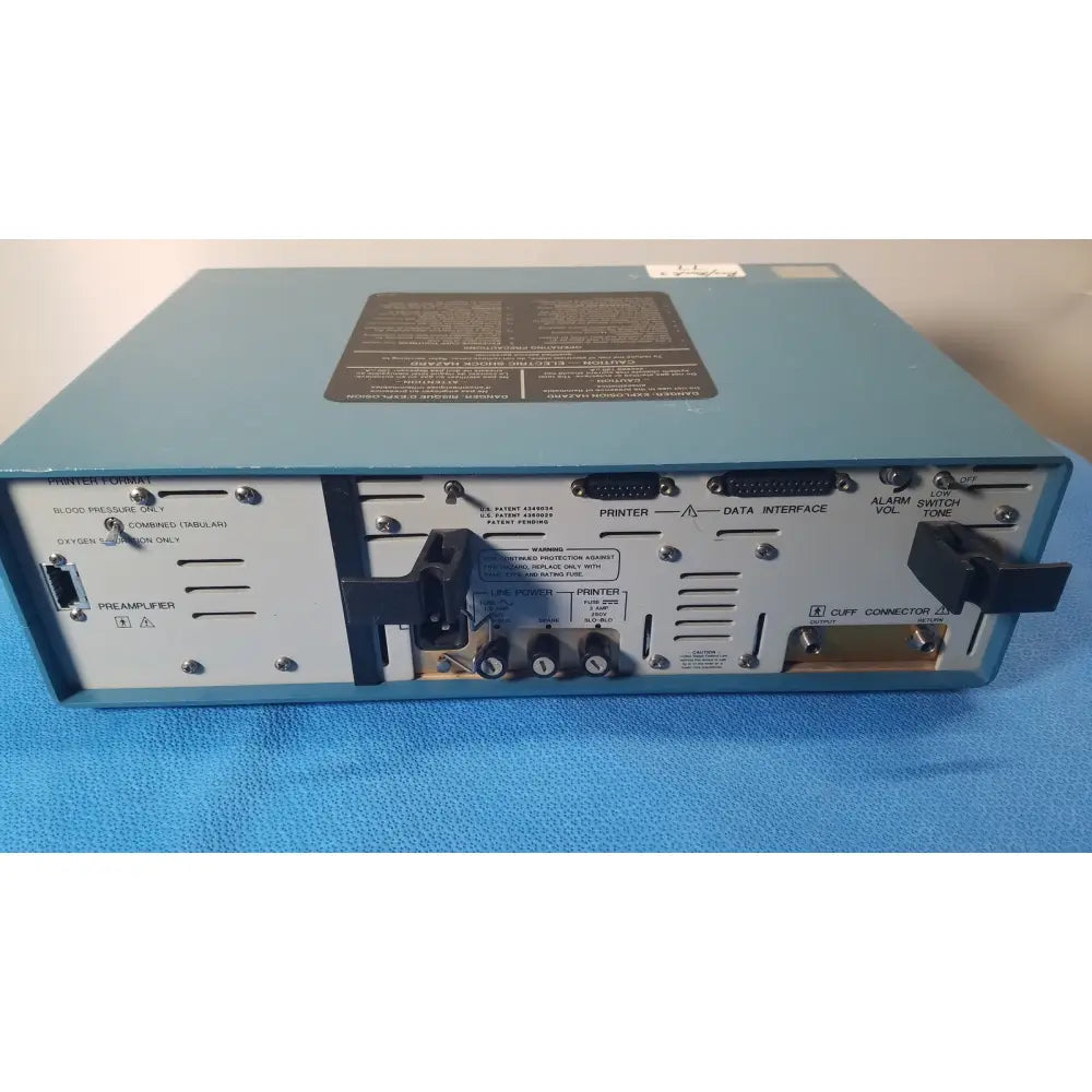 Light blue rear panel of critikon dinamap 1846 sx vital signs monitor with black labels and ports for vital signs use