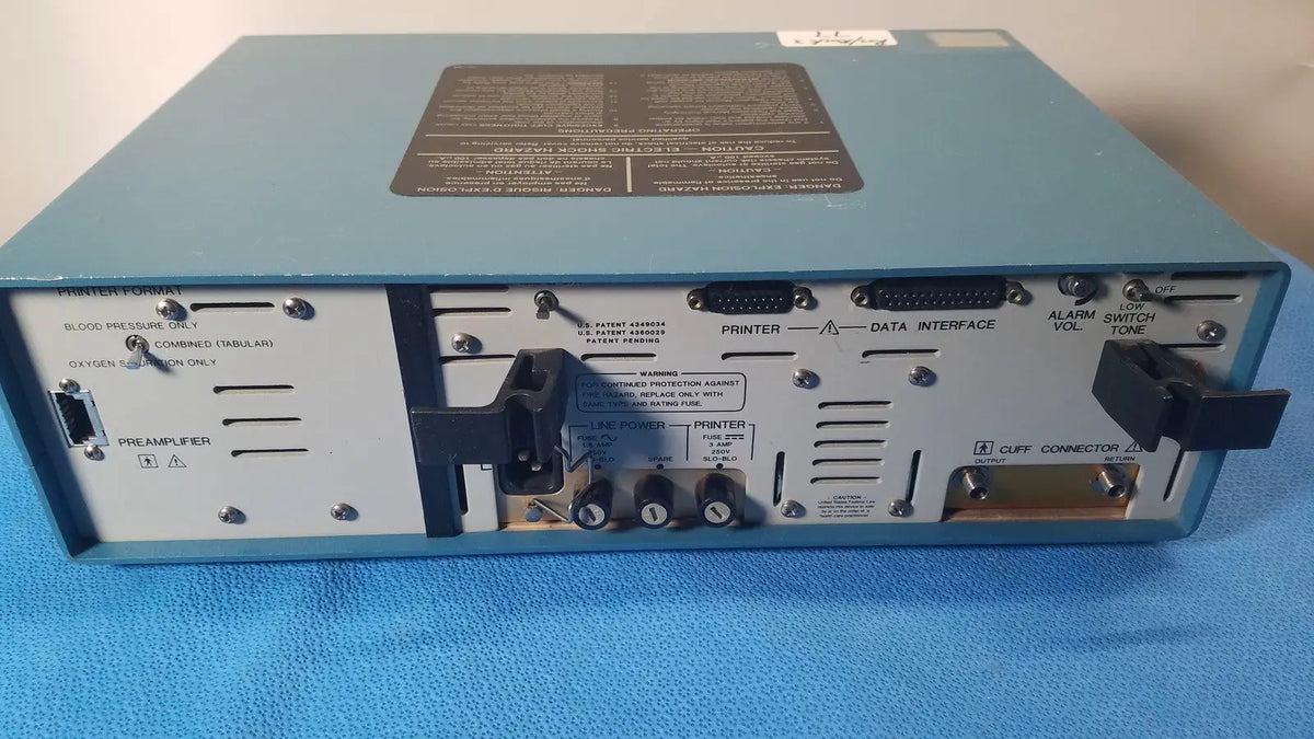 Light blue rear panel of critikon dinamap 1846 sx vital signs monitor with black labels and ports for vital signs use