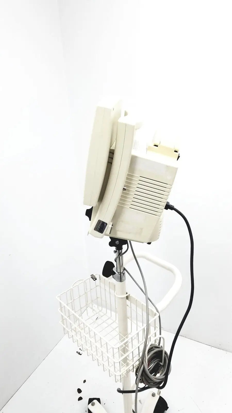 Beige csi criticare 8100 series poet plus vital signs patient monitor mounted on white adjustable stand with wire basket