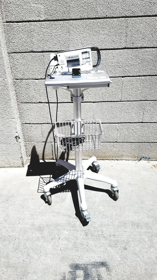 White medical cart with wheeled base and metal basket holding cubescan biocon-700 for bladder volume measurement