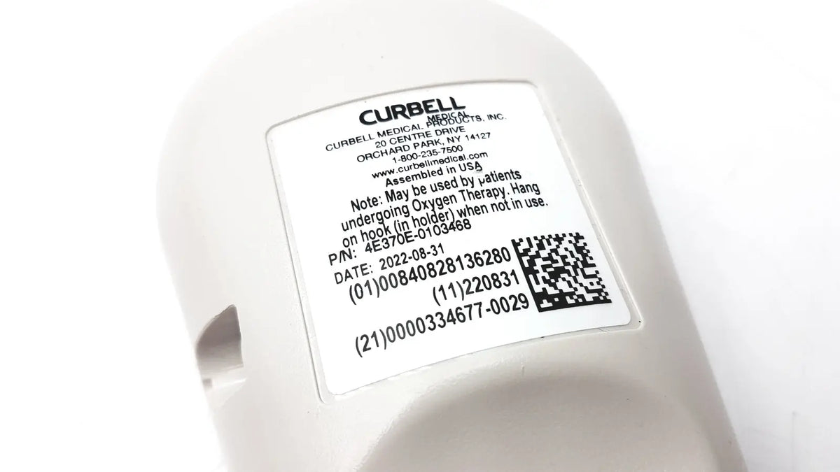 White plastic medical oxygen delivery device with manufacturer label on curbell getwell network nurse call remote