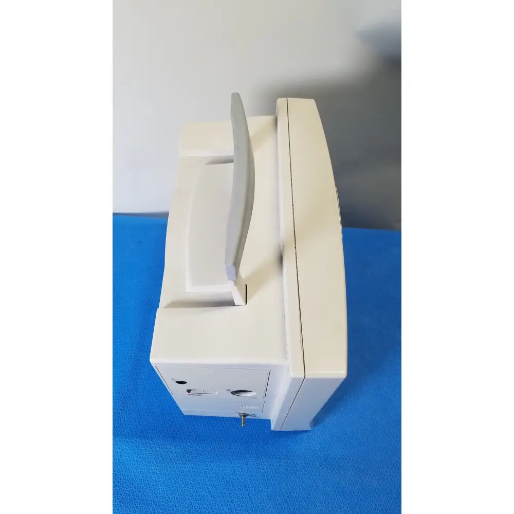 Cream-colored plastic datascope passport 2 ecg nibp ekg patient monitor with curved screen and integrated handle