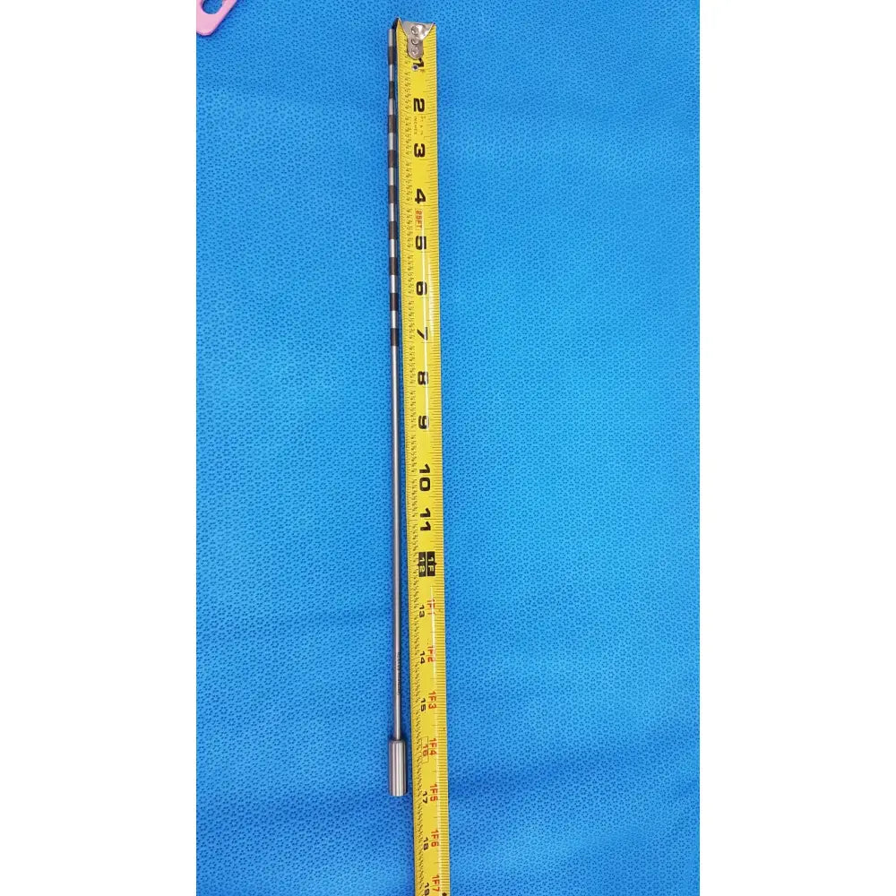 A slender metallic geck surgical instrument model 8381-01 with yellow measuring tape for scale