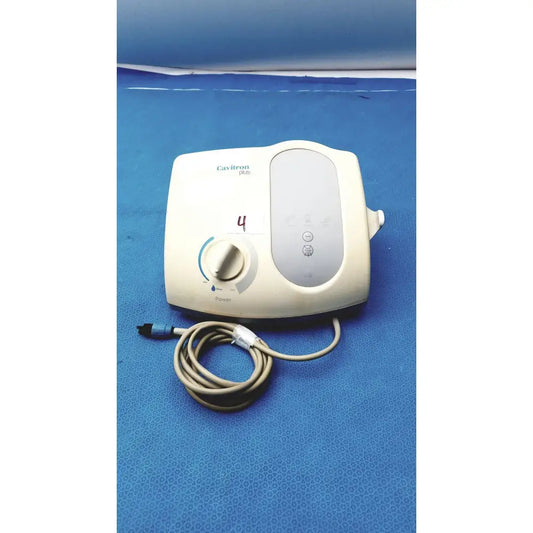 Cream-colored dentsply cavitron plus ultrasonic scaling unit with coiled beige power cord and control dial type GEN-136