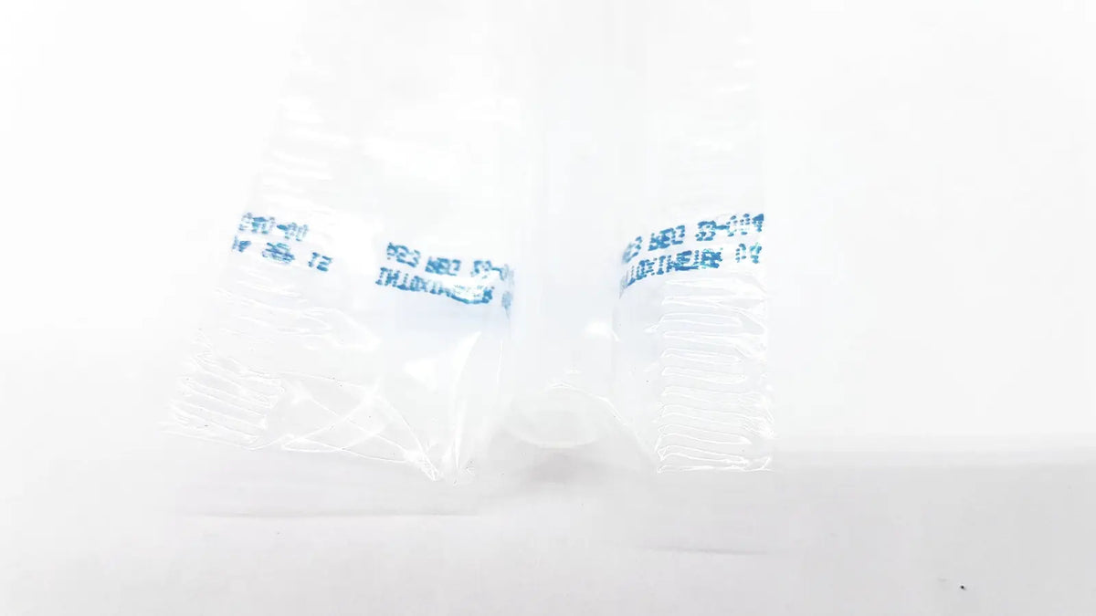 Clear plastic packaging with blue text containing a small white object for disposable dental things reuse medical use