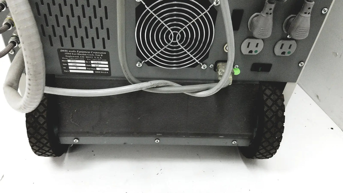 Gray industrial-grade dental delivery unit with black rubber wheels and ventilation fan on back panel by DNTL Works