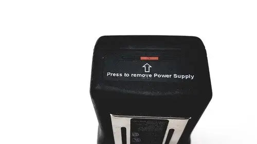Black rectangular power supply unit with red indicator light on the back of drager multi-gas monitor for reuse medical purposes