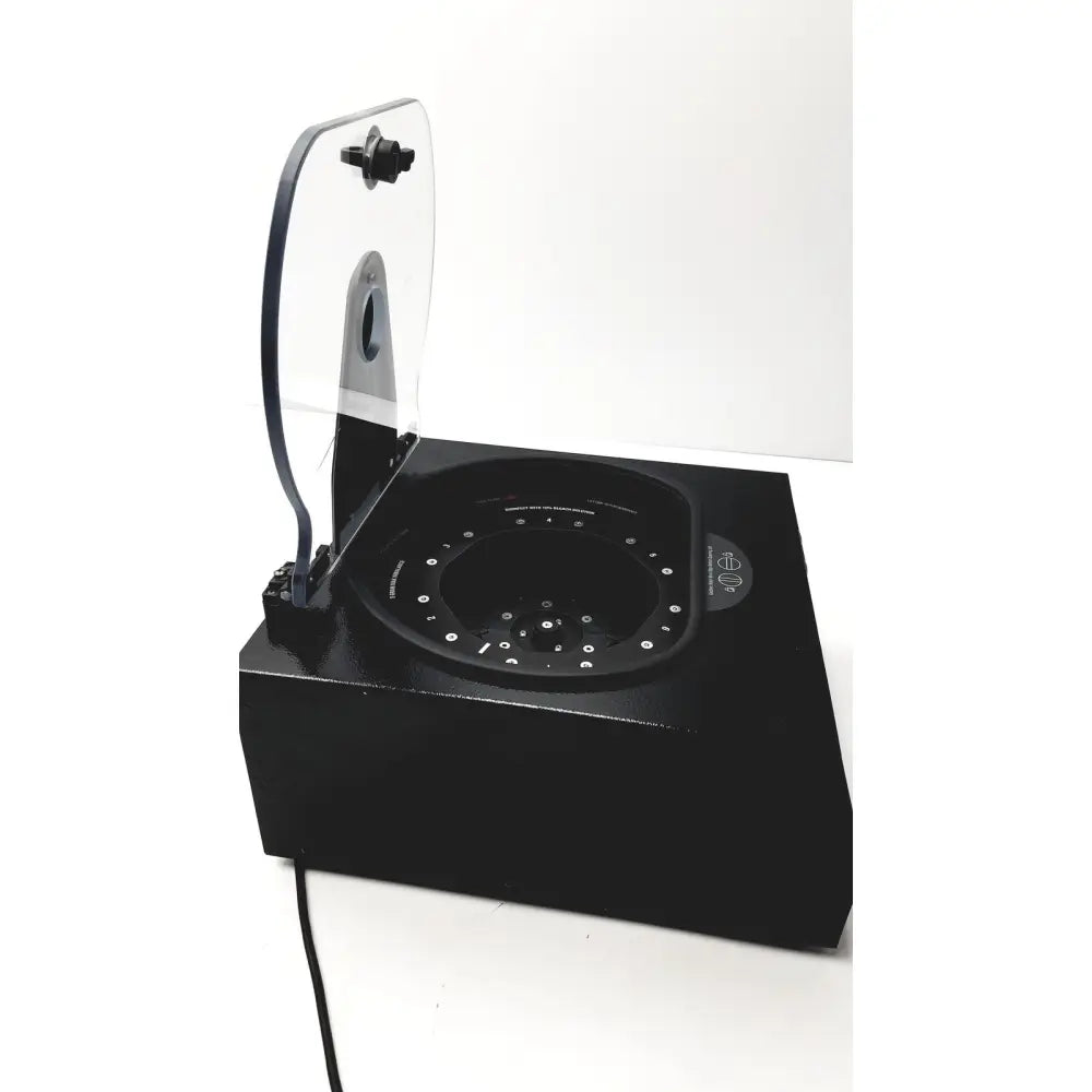 Black rectangular drucker diagnostics dash apex 24 centrifuge with transparent hinged lid and circular interior with white dots