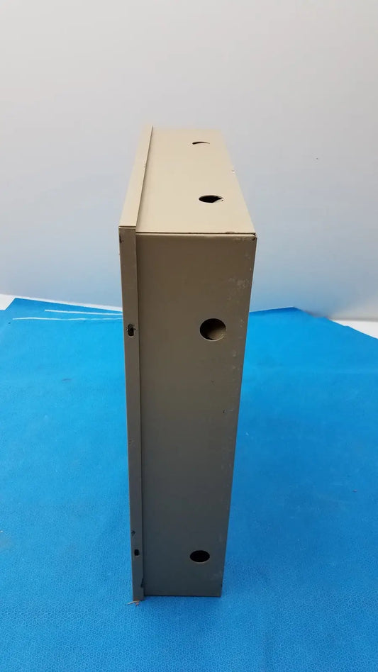 Beige metal electrical control panel enclosure with evenly spaced circular holes featuring time delay relay and transformers