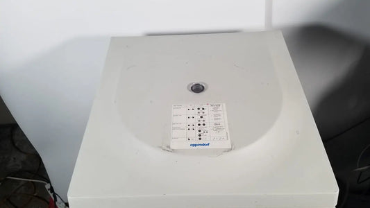 White plastic eppendorf centriifuge model 5810 with circular lid and control panel for laboratory use