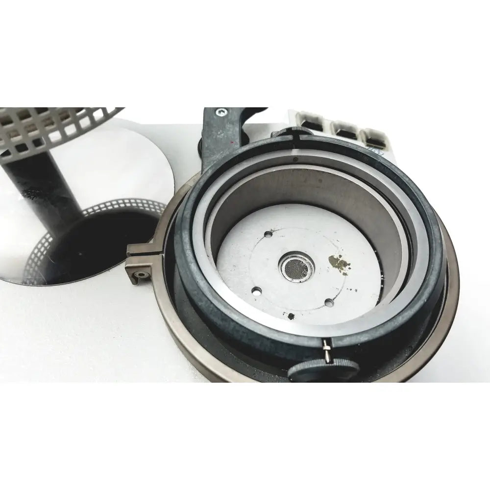 Metallic silver circular component with black rubberized ring and mesh filter for erkodent erkoform-rve dental lab thermoforming system