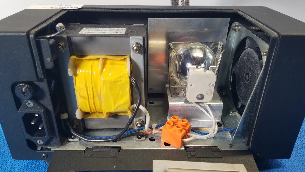 Black electronic device housing with yellow transformer silver lamp and orange connectors on fisher scientific dual fiber-optic illuminator