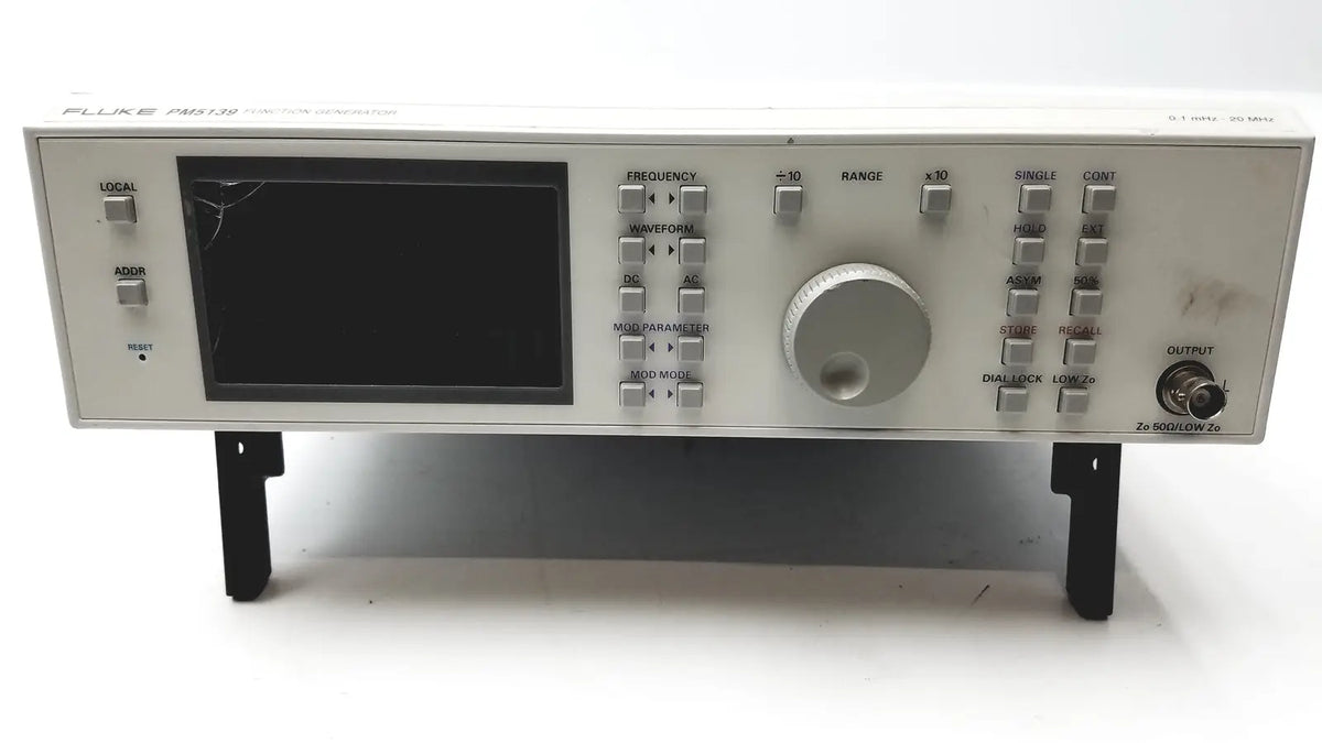Silver fluke pm5139 function generator with black screen, multiple control knobs, buttons, and output port for signal testing