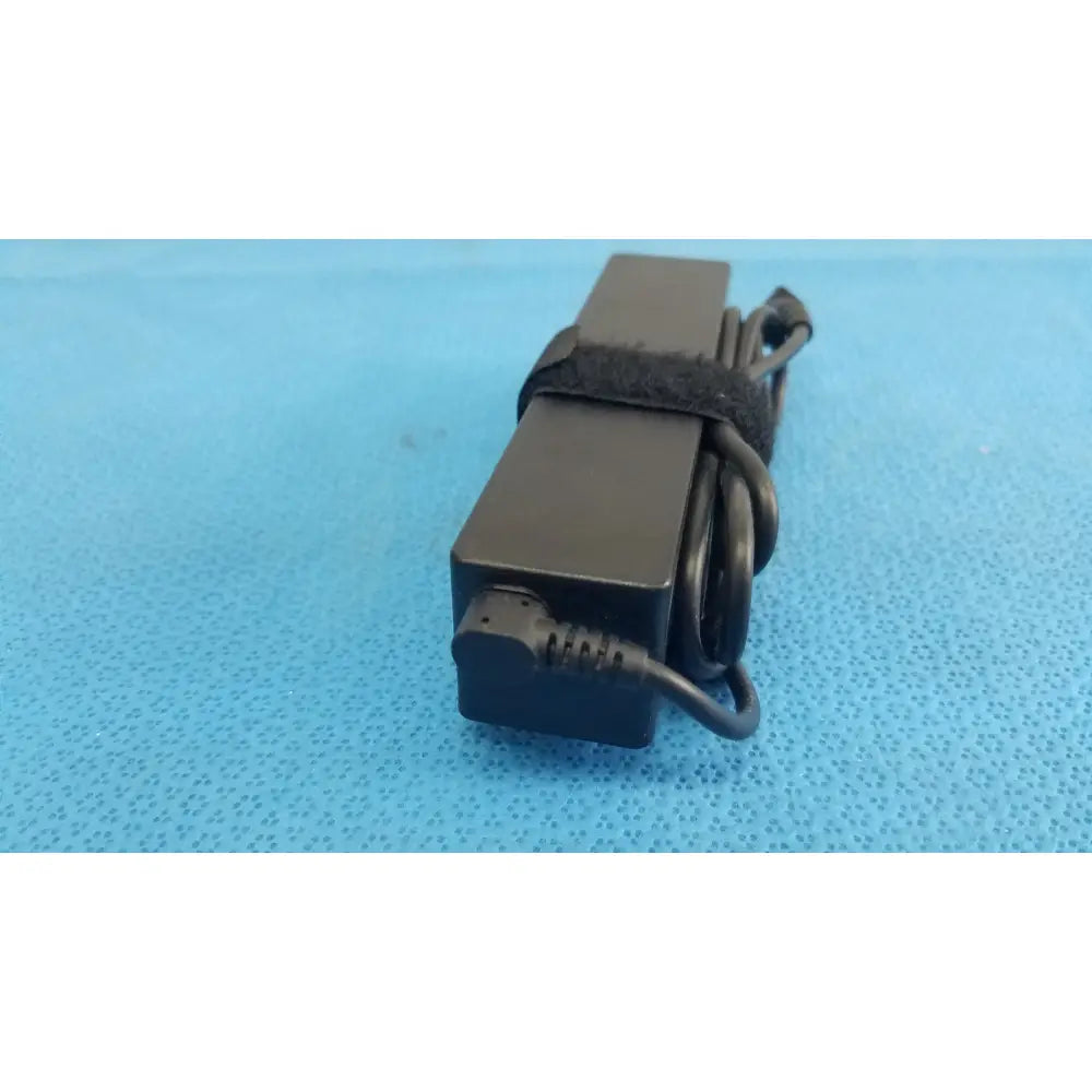 Black rectangular fujitsu ac adapter power supply 19v 3.16a with coiled cord and black strap for laptop use