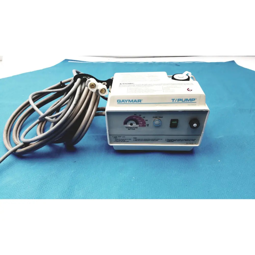 White and gray Gaymar T/Pump TP500C medical-grade pump heat therapy device with coiled black power cord