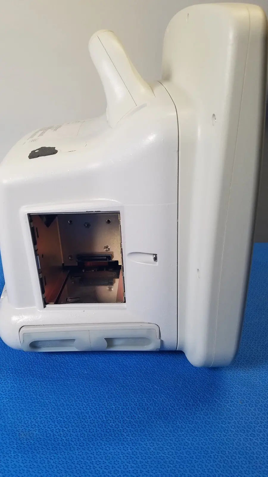 White plastic GE Dash 5000 patient monitor ECG with rectangular opening showing internal components for ECG monitoring