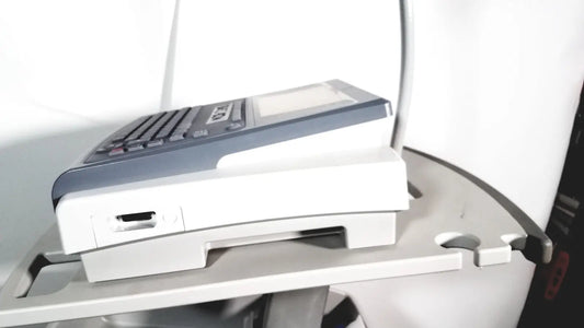 Gray and white handheld GE Mac 1600 ekg ecg analysis terminal with keypad and USB port for lead resting patient monitoring