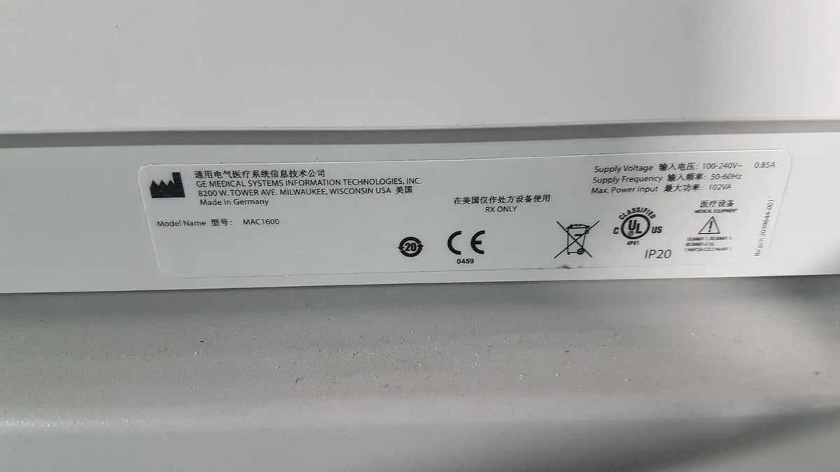 White rectangular label on the back of a medical mac1600 ecg device showing model mac1500 specifications and symbols
