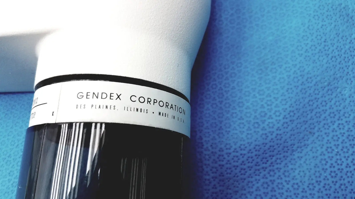 White and black cylindrical tube head for imaging equipment by gendex corporation for reuse medical applications