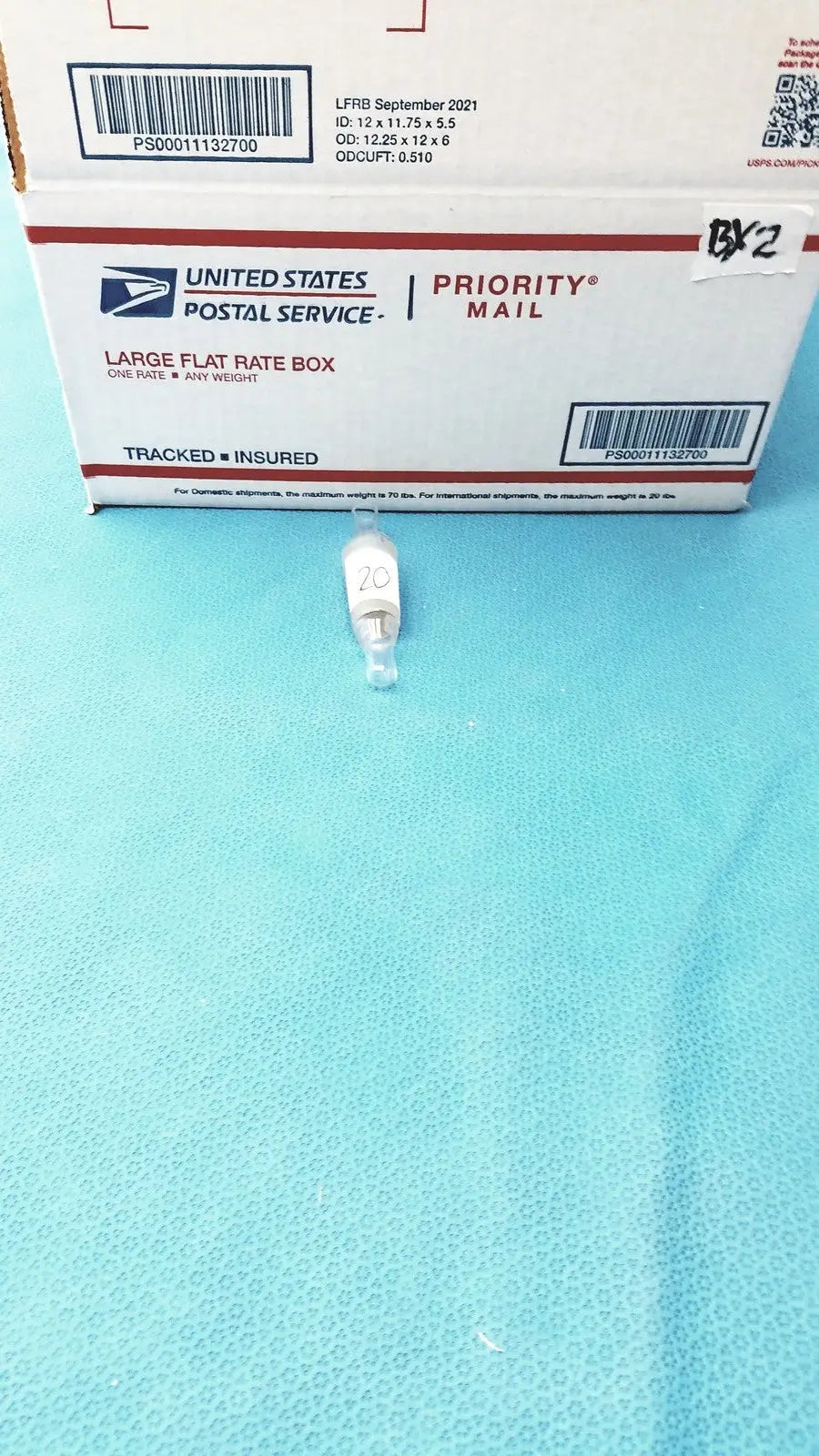 Clear glass thermometer adapter with white label marked 20 and metallic base for standard taper joint use