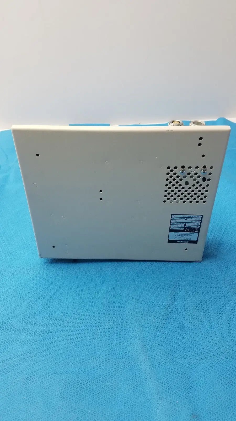 White rectangular medical monitor back panel with ventilation grille and certification label for globalmed jedmed xe30-eco
