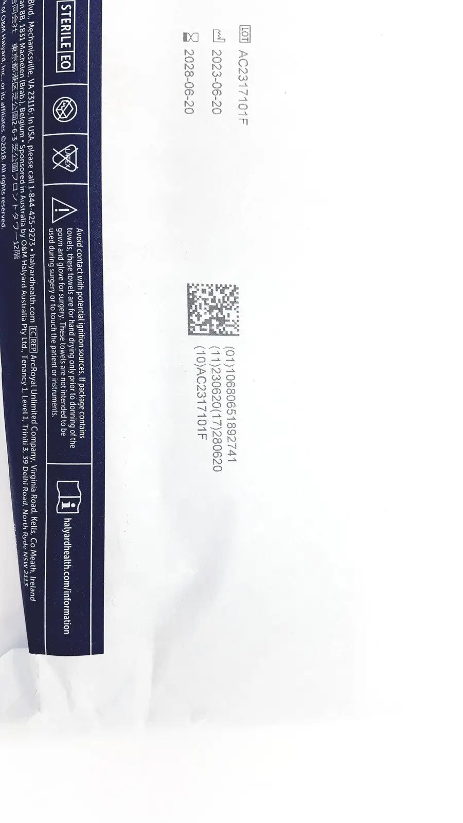 White paper packaging with navy blue label showing product info and barcode for halyard 89274 orthoarts shoulder split drape
