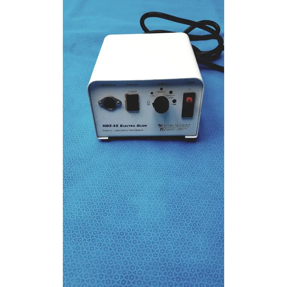 White rectangular electronic laboratory power supply with black knobs labeled hdz-35 electra guide by henry schein zahn