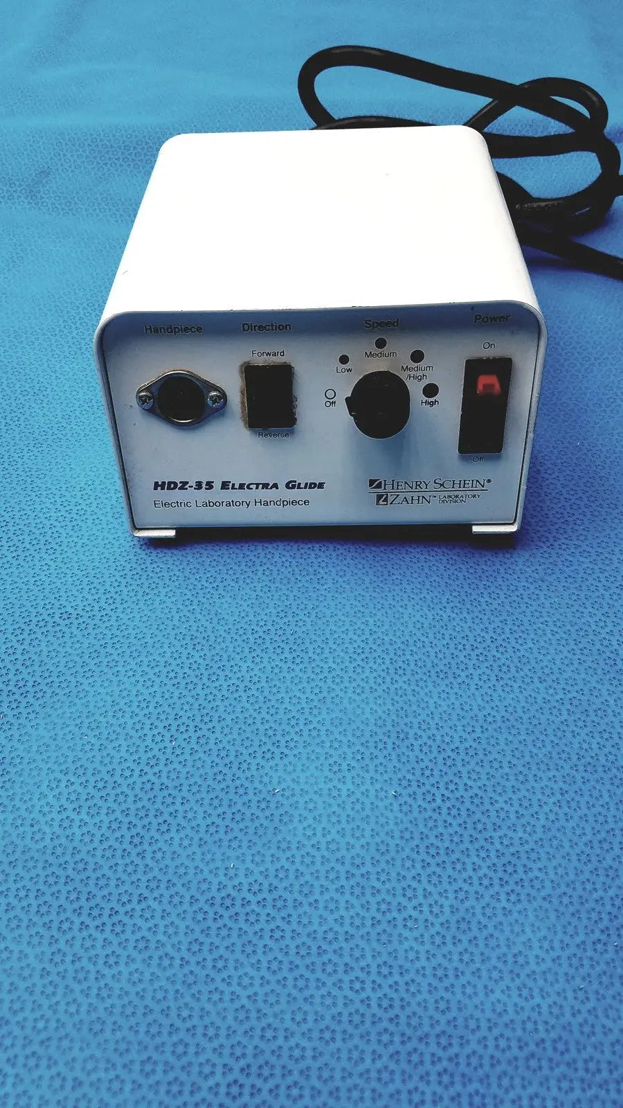 White rectangular electronic laboratory power supply with black knobs labeled hdz-35 electra guide by henry schein zahn