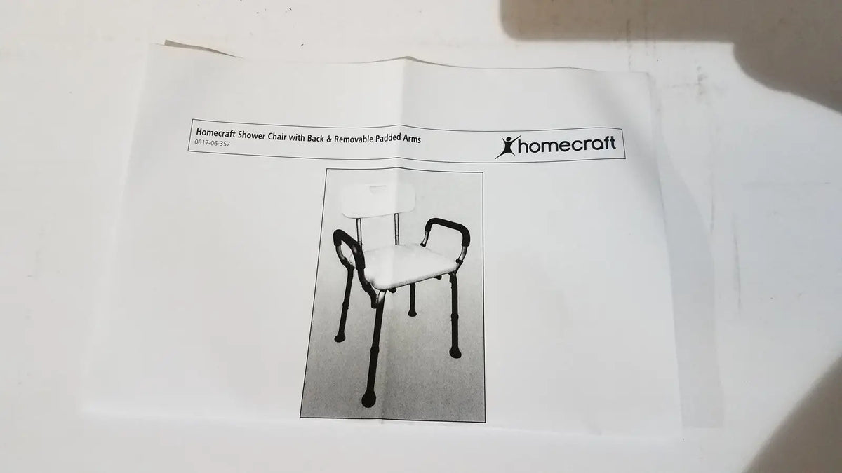 Homecraft shower chair with backrest and padded removable arms features white seat and backrest with black metal legs