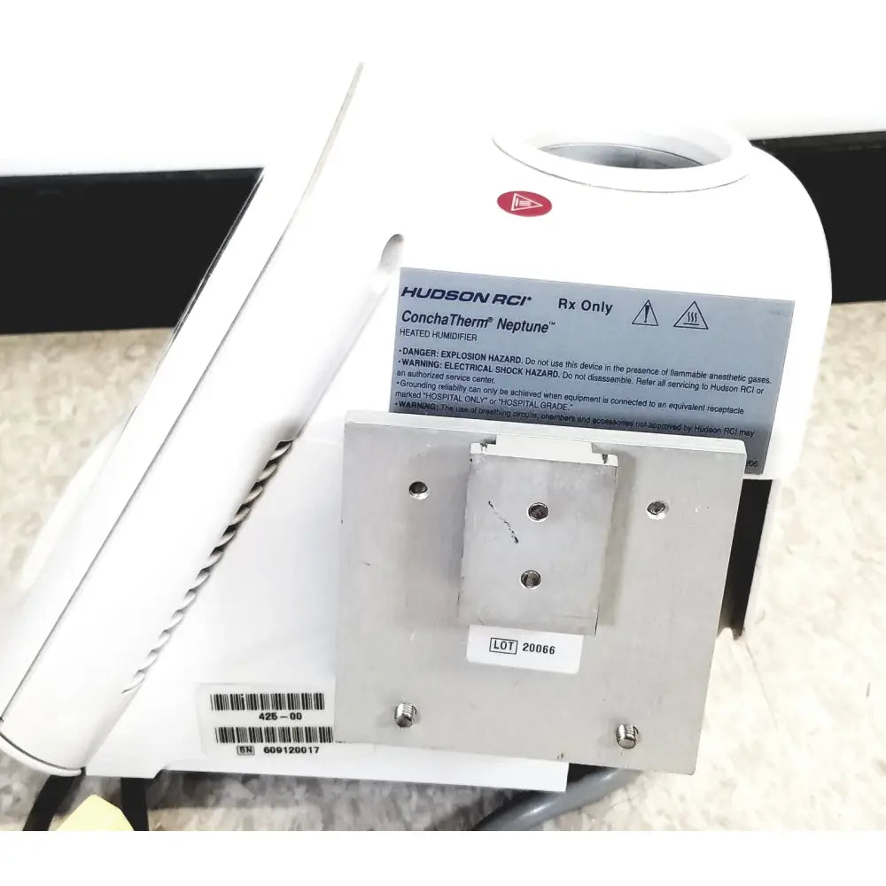 White hudson rci conchatherm neptune heated humidifier with metallic mounting plate and warning labels visible