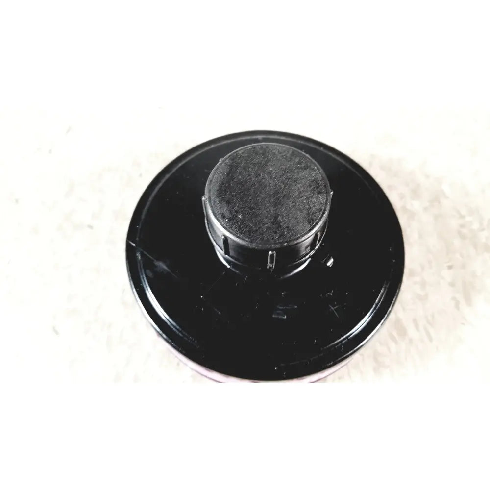 Black plastic ilc dover s-4002 filter with textured circular top and ridged edges for sentinel xl powered air system