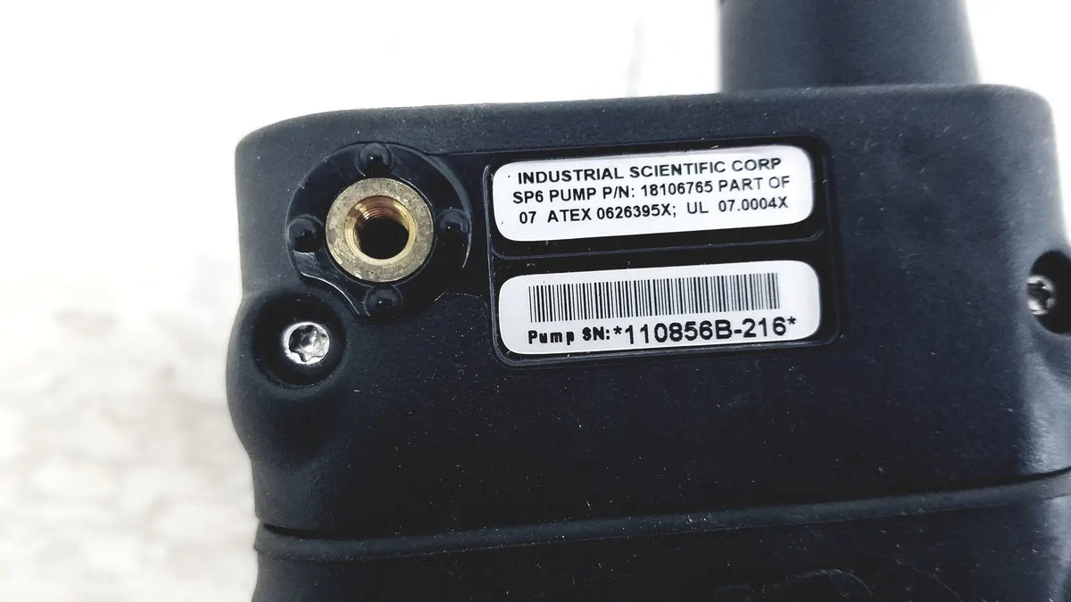 Black industrial sp6 pump with brass fittings and part number label shown with industrial scientific mx6 ibrid handheld monitor