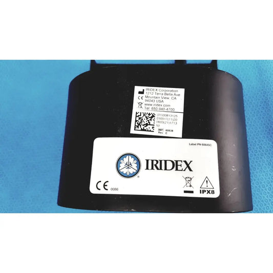 Black iridex laser foot switch footpedal waterproof housing with circular logo and regulatory labels on rear side