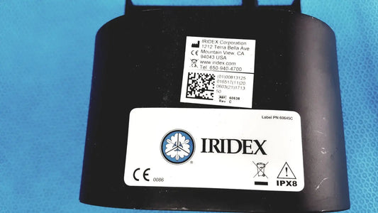 Black iridex laser foot switch footpedal waterproof housing with circular logo and regulatory labels on rear side