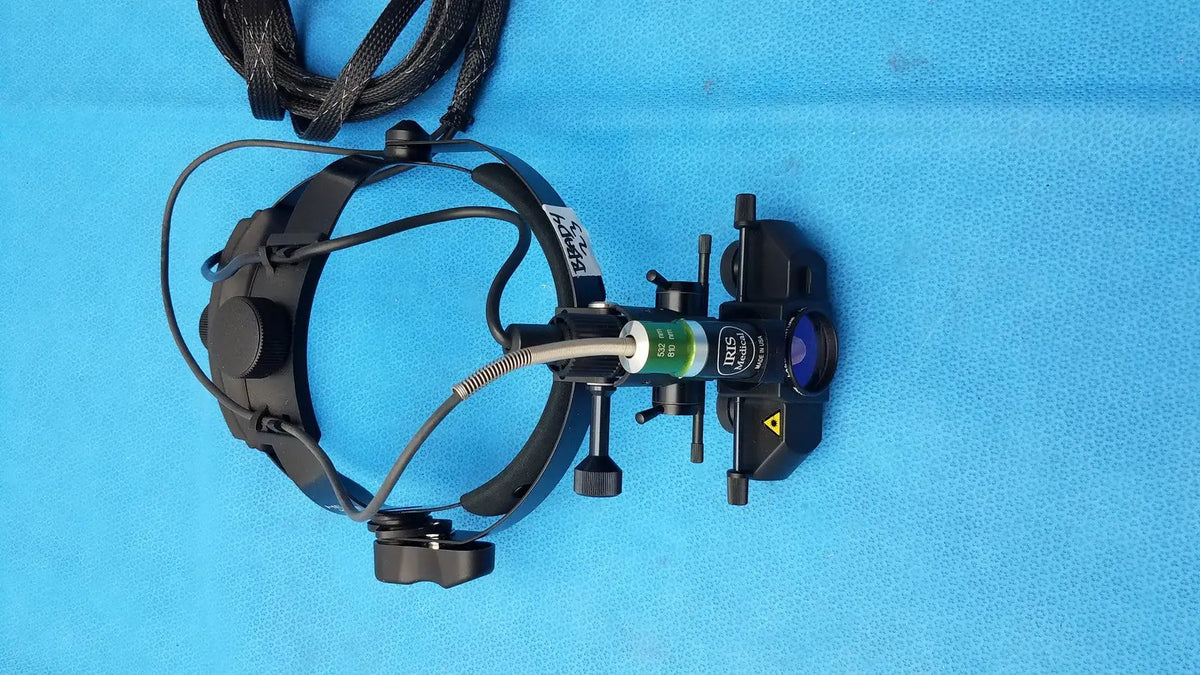 Black surgical headlamp with adjustable arms and green-labeled lens housing for iris medical laser indirect ophthalmoscope