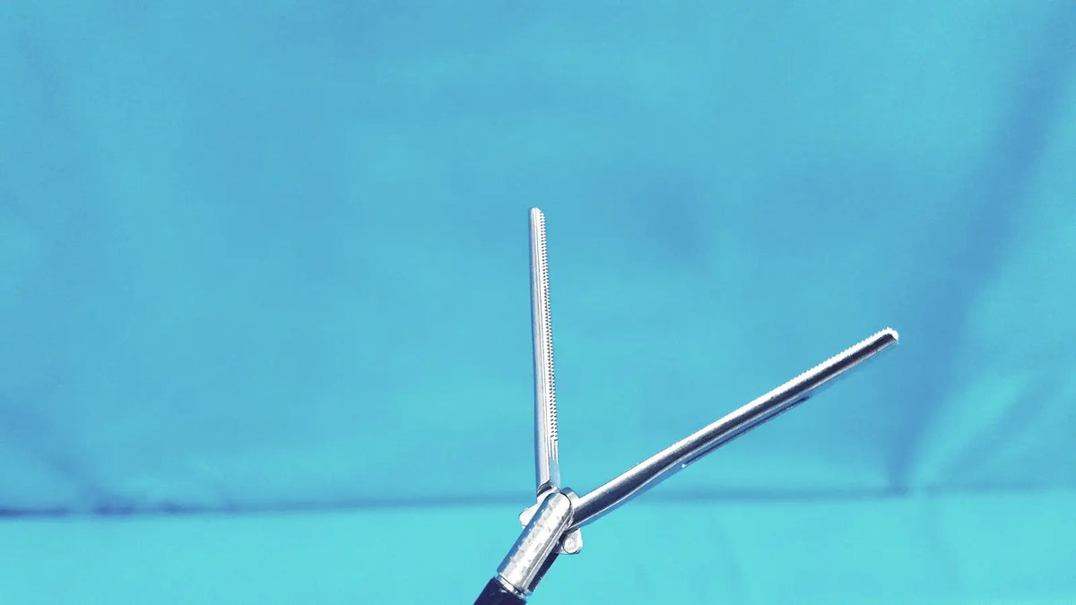 Jarit 610-140 stainless steel roto-lok surgical forceps with silver serrated tip and polished handles