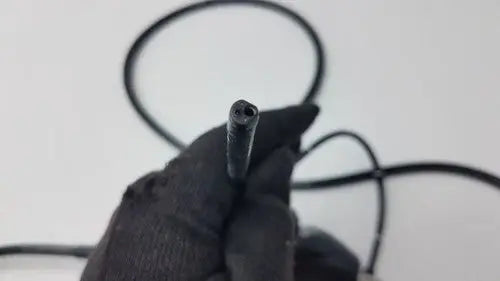 Black rubber-coated cable end with threaded metal tip of karl storz storz 11272vnu flexible video endoscope back side