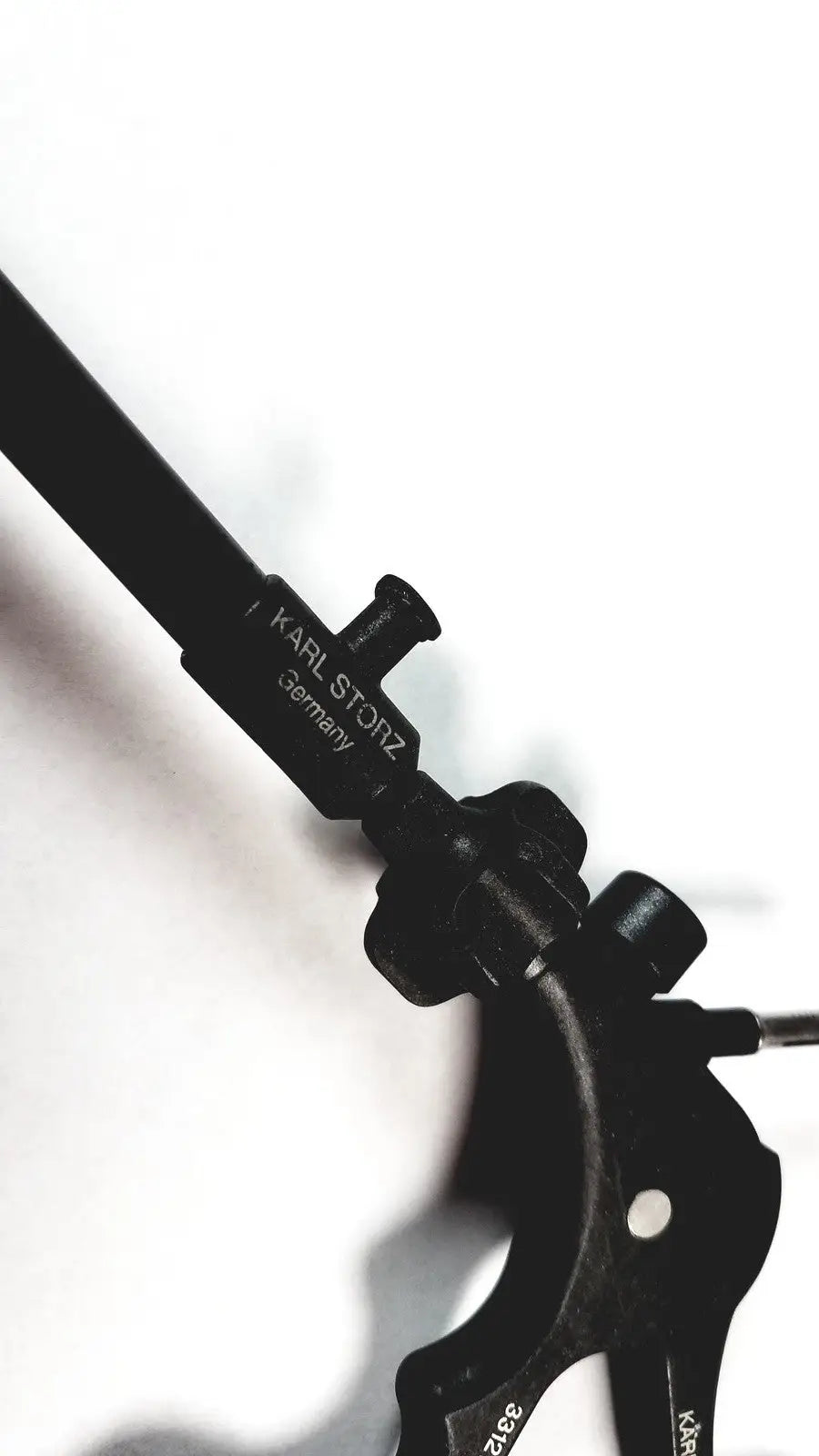 Black metal karl storz clickline handle with tube for laparoscopic instruments engraved with karl storz germany