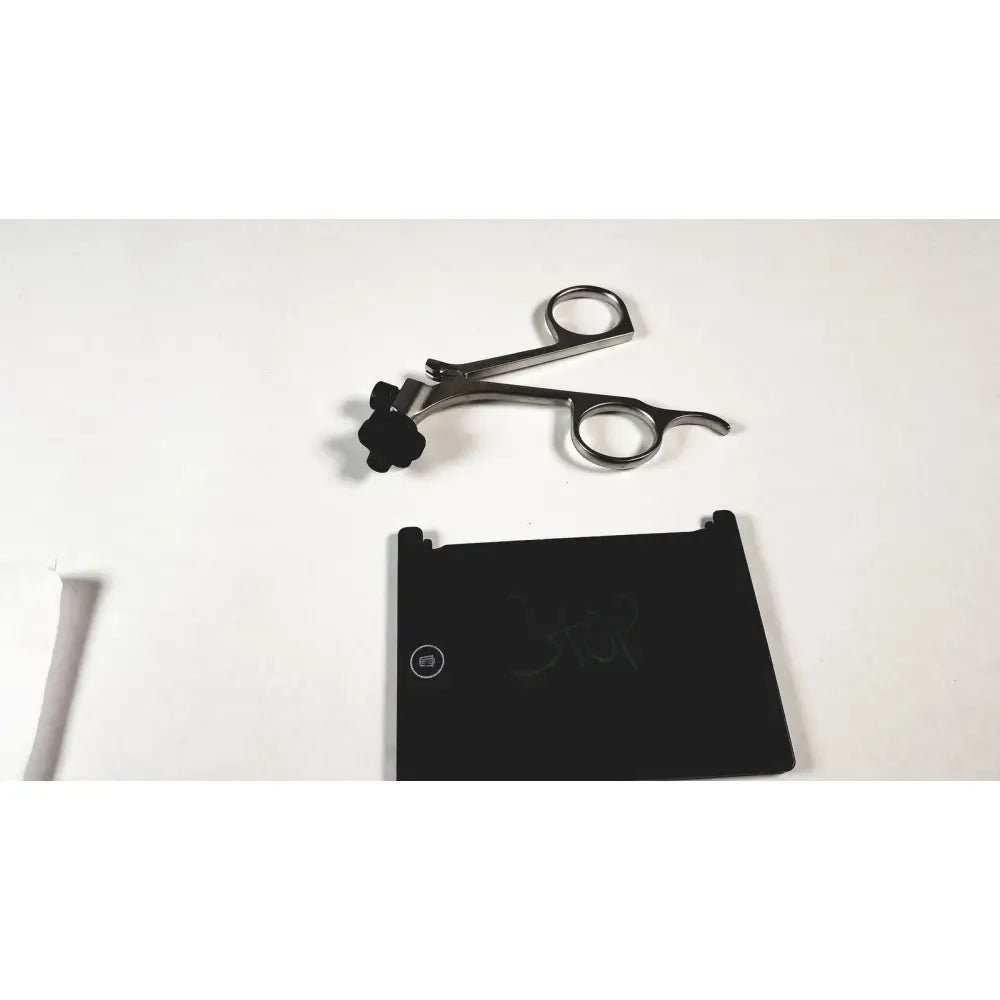 Silver surgical instrument with black rubberized grip and curved handles featuring karl storz clickline metal handle pistol grip