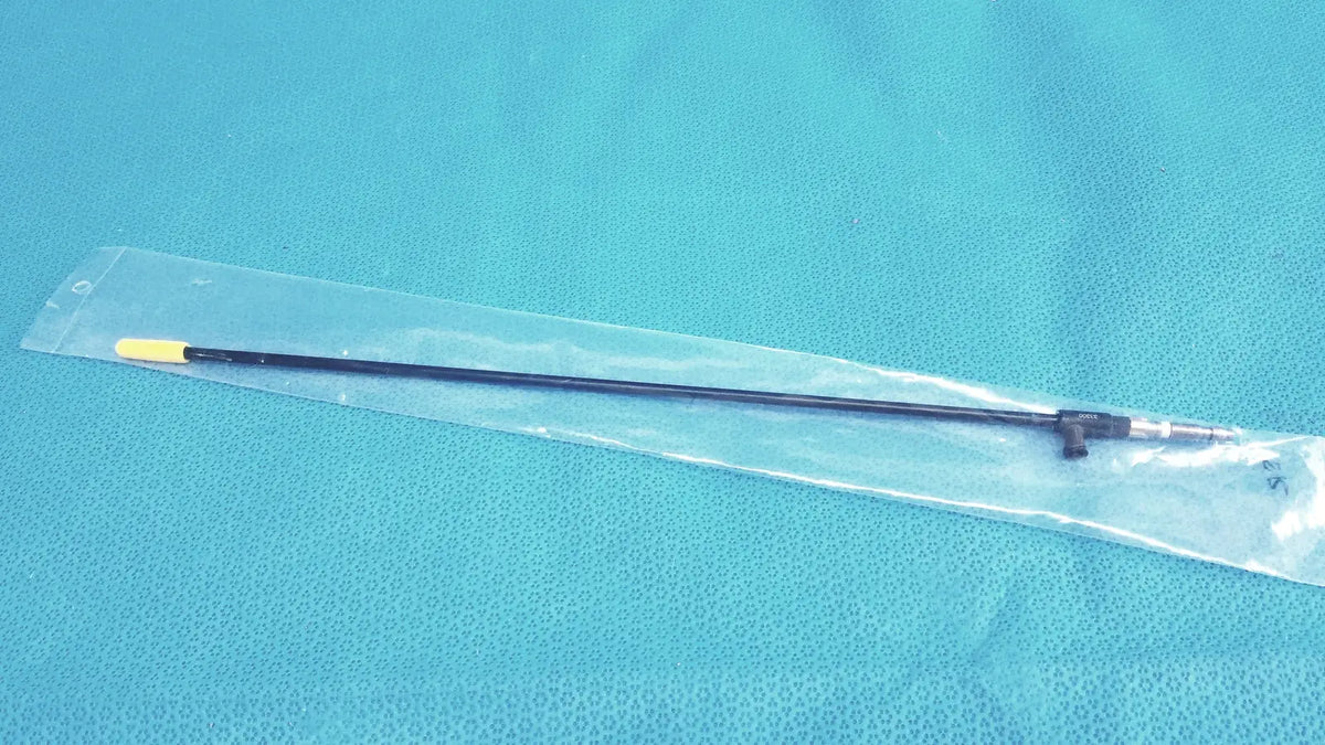 Black karl storz insulated outer tube with yellow tip and metallic joint packaged in clear plastic for surgical use