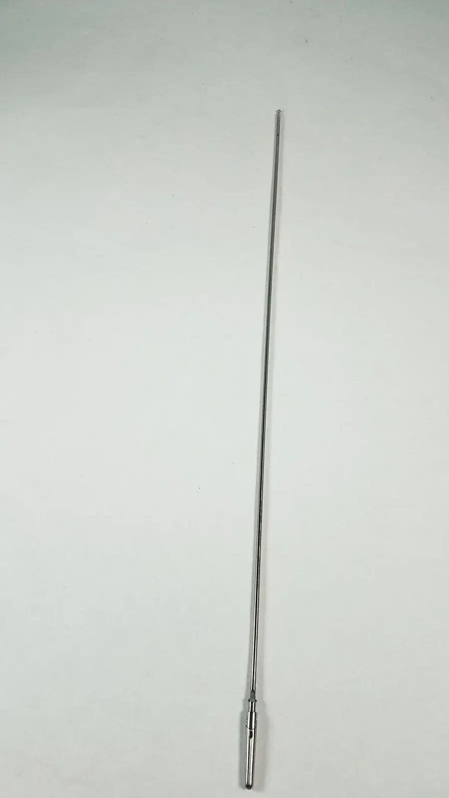 A sleek polished chrome karl storz clickline grasping insert surgical endoscopy instrument with a cylindrical base attachment