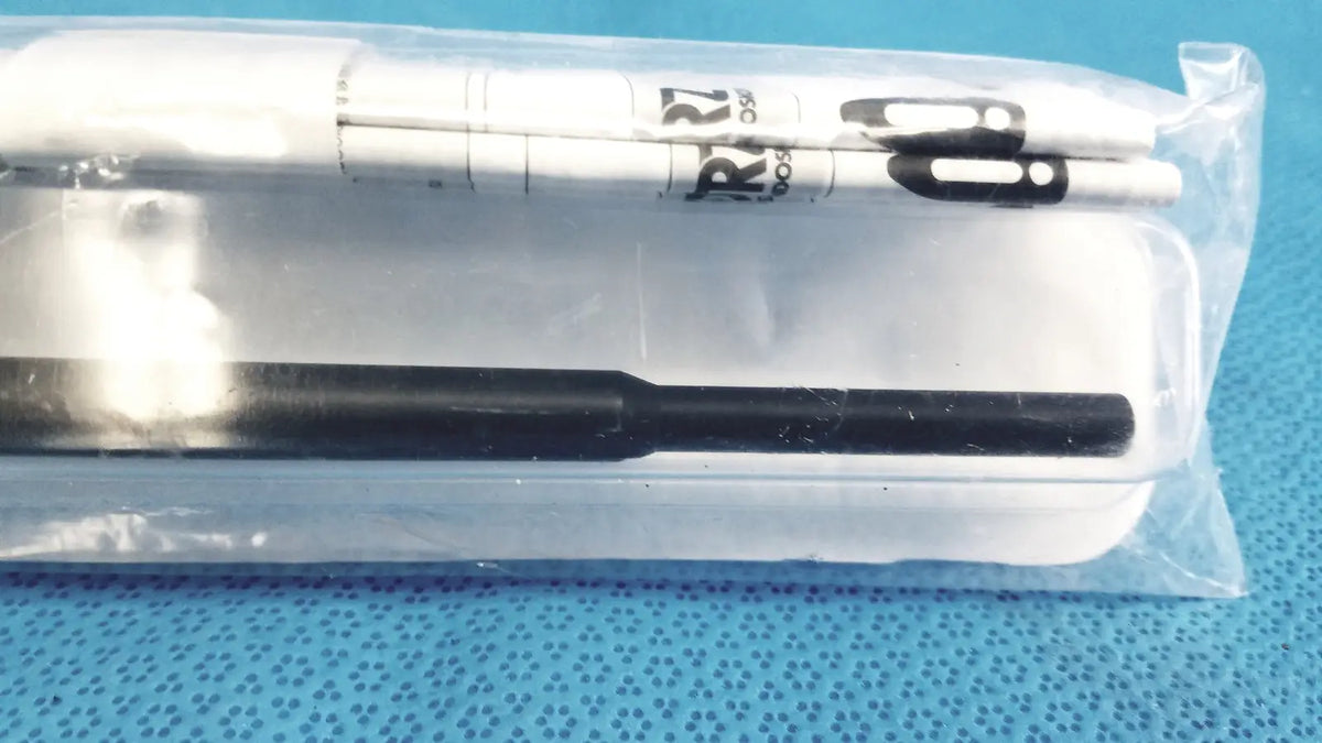 White and black marker pens in clear plastic packaging alongside karl storz clickline insulated outer sheath tube