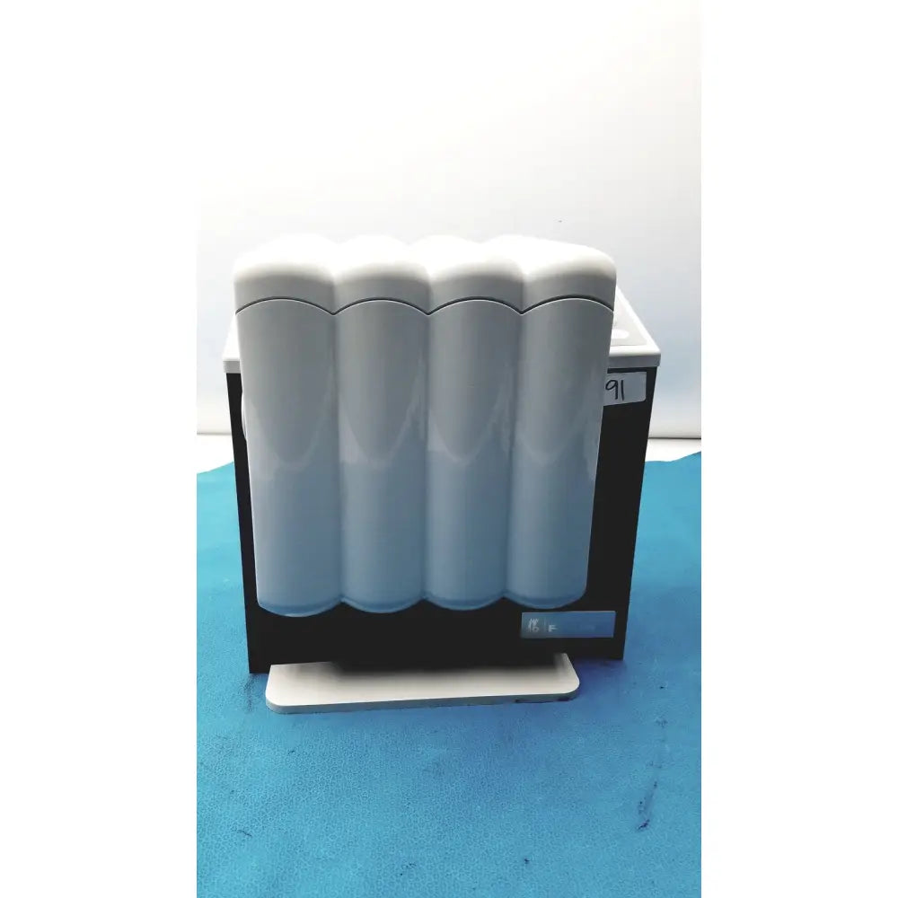 White cylindrical filter cartridges mounted in black and white housing of kavo quattrocare plus 2124a system
