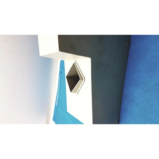 White and black geometric wall-mounted trash receptacle with metallic diamond opening on kirby lister kl15 pharmacy table