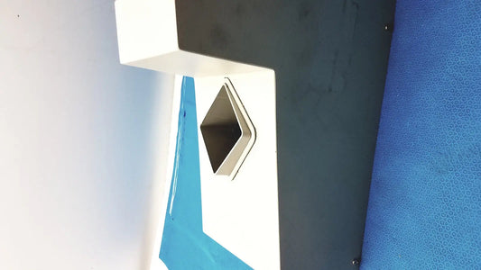 White and black geometric wall-mounted trash receptacle with metallic diamond opening on kirby lister kl15 pharmacy table