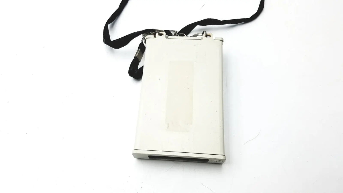 White rectangular laerdal compact suction unit with black strap attached to top for portable medical use untested
