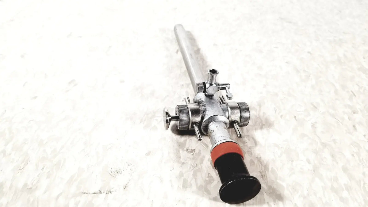 Silver-colored linvatec conmed hasson laparoscopic valve with black handle red accent and multiple control knobs ports