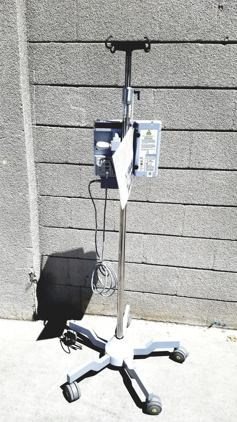 Masimo mridium 3600+ silver and white medical iv stand with four caster wheels for mri infusion pump monitoring systems