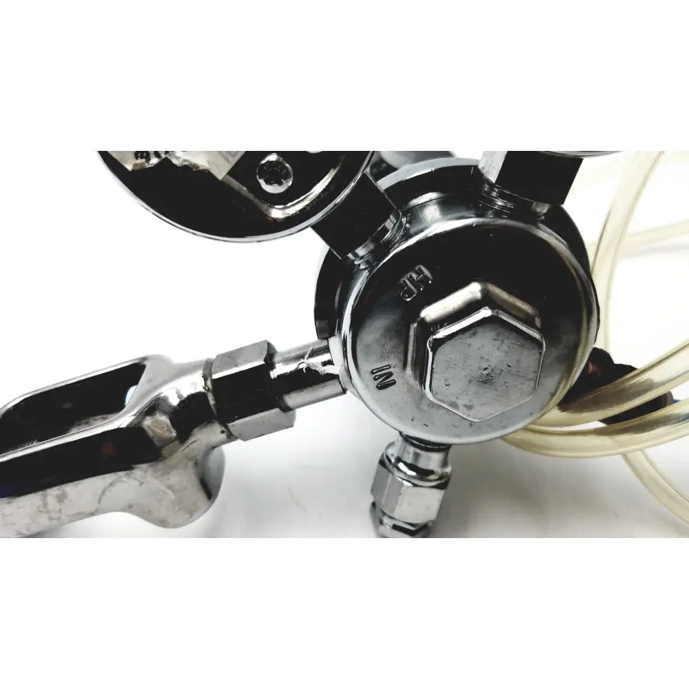 Chrome-finished medical graphics corp comprressed gas regulator with hexagonal nuts and visible pressure gauge for calibration use