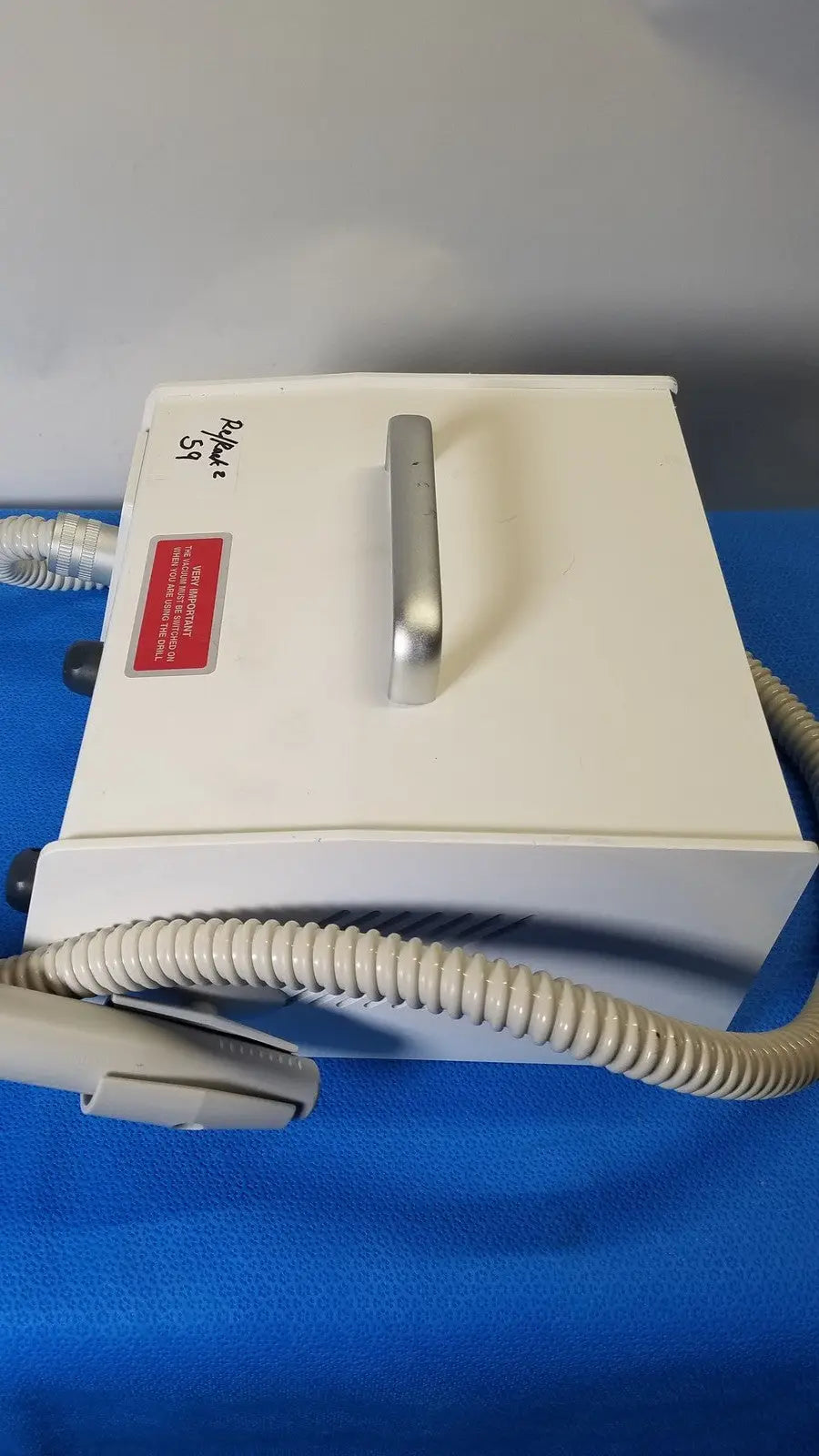 White rectangular medicool pro vac file v2 dust collector vacuum system with silver handle and beige coiled tubing